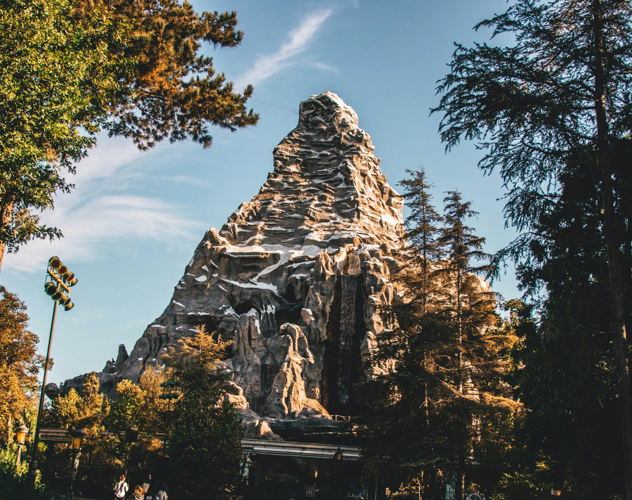 Beautiful view of the iconic Matterhorn Mountain at Disneyland with clear skies and trees.