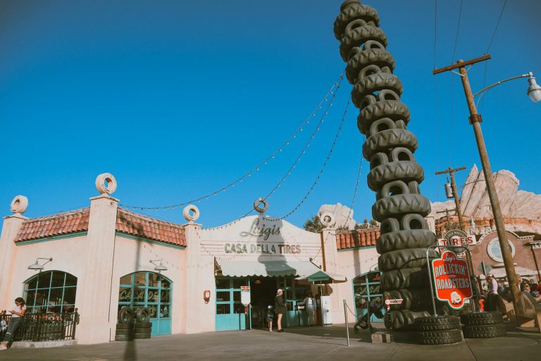Vibrant image of a unique tire shop with a towering stack of tires and classic architecture.